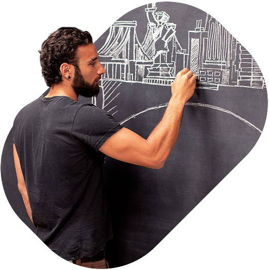 Marco Zagaria smiling confidently, with design sketches in the background.